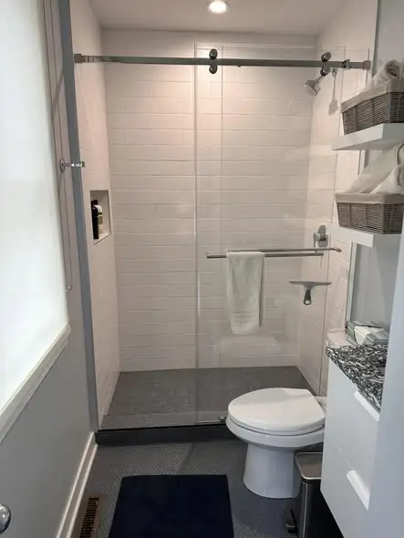 Compact sliding shower door